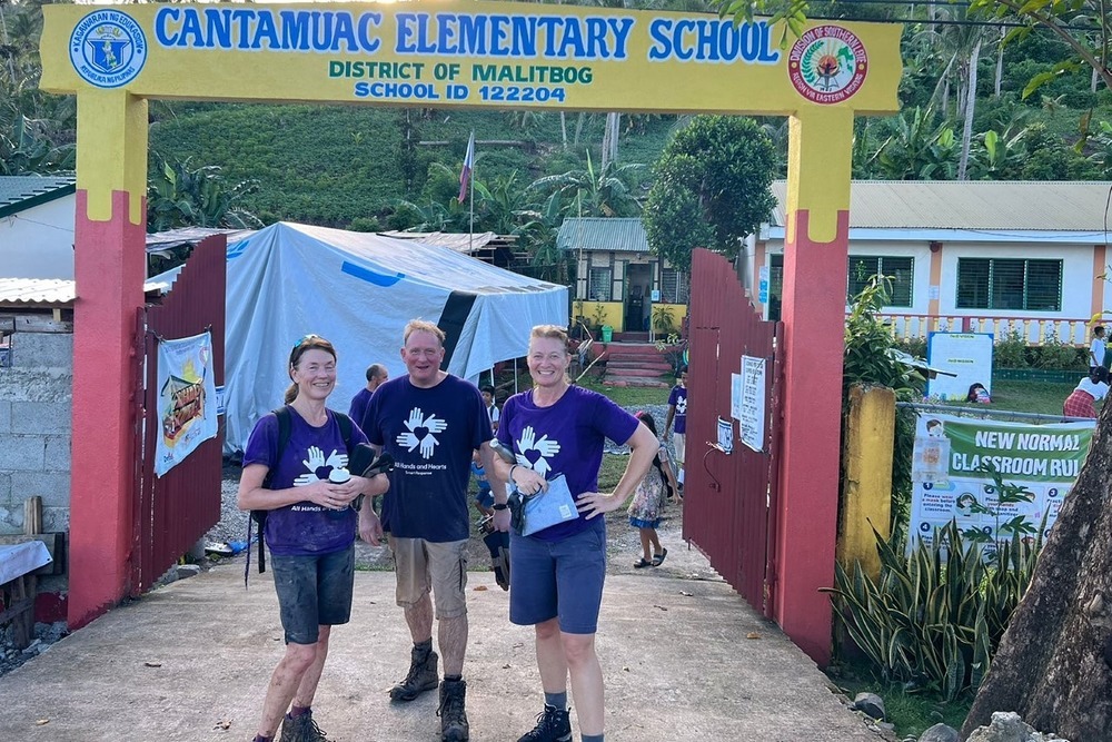 Burgess is so proud of Julie, Andrew and Marie (l-r) for taking up the challenge to help build a school in the Philippines