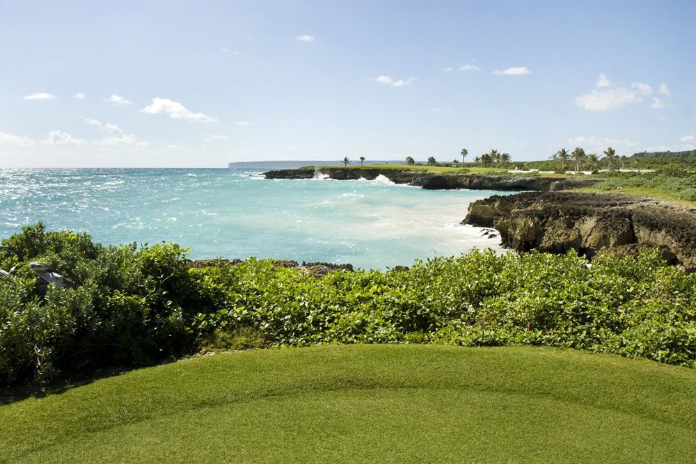 Admire the beautiful beachfront scenery between holes