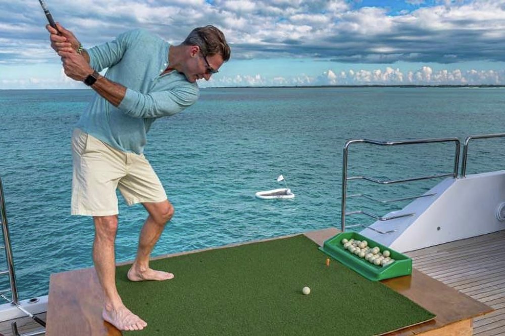 While you're waiting for the match to start, you can practice your swing while feeding the fish with biodegradable fish-food golf balls