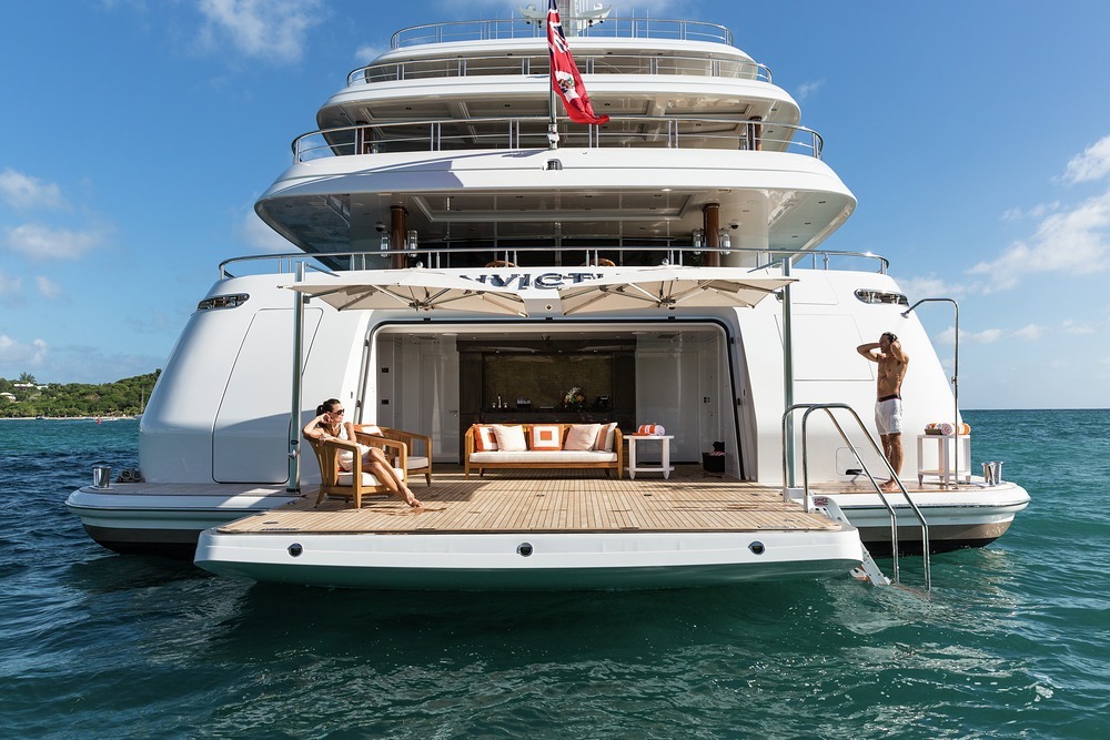 Full-beam tender garage which opens up to port and starboard for launching tenders and toys