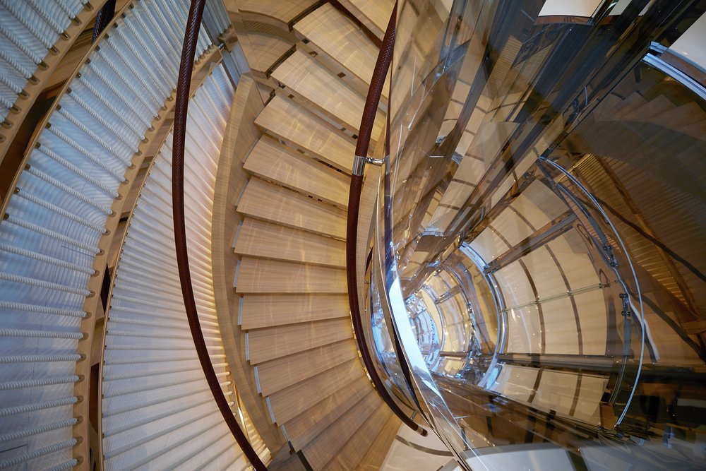Spiral stairs around the steel and glass elevator