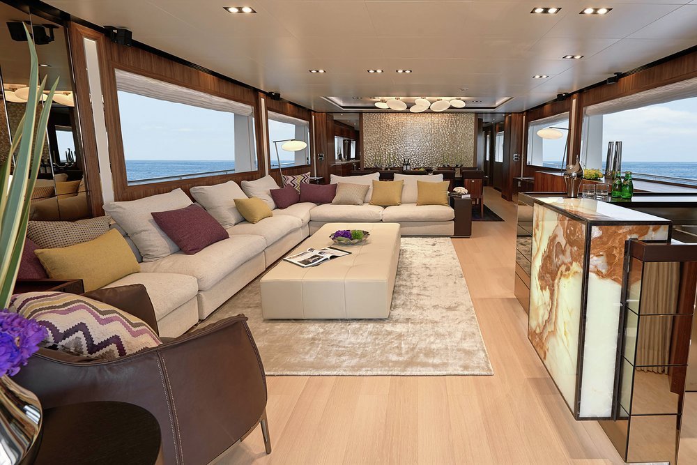 Full-height sliding glass doors open into the main saloon
