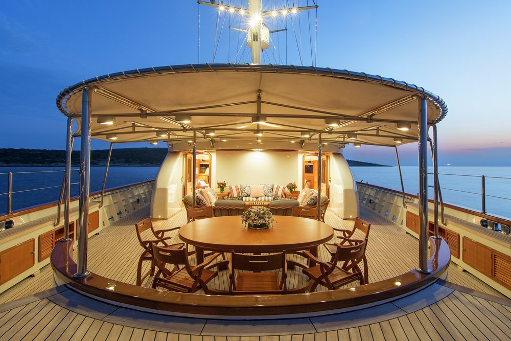 Open-air dining and lounging on the main deck aft
