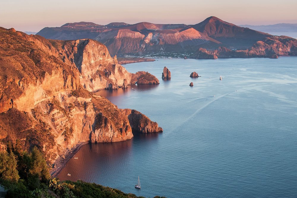 Sunset on the cliffs and the island of Vulcano visible in the background