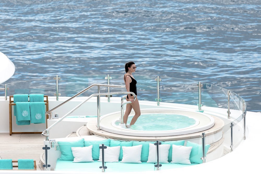Soak up the sun and sip on a cocktail as you relax in the yacht's sun deck jacuzzi